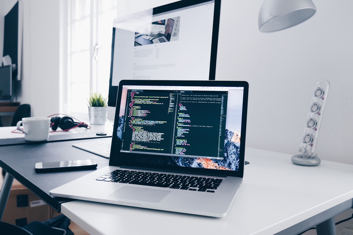 Fintech analyst reviewing payment orchestration metrics on dual monitor workstation